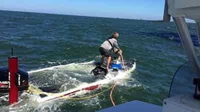 bass boat sinking in rough water on open water lake