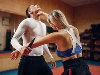 self-defense-class woman fighting man with upper cut to throat