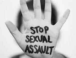hand stop with writing stop sexual assault in black ink