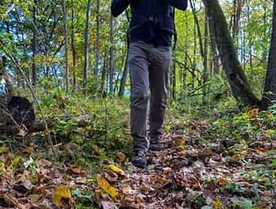 man hiking on trail in woods