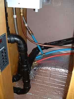 plumbing in rv behind door storage